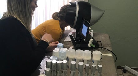 A skin analysis at YourSkin Beauty Clinic, Pretoria, Gauteng, ZA. Woman using equipment with beauty products displayed.
