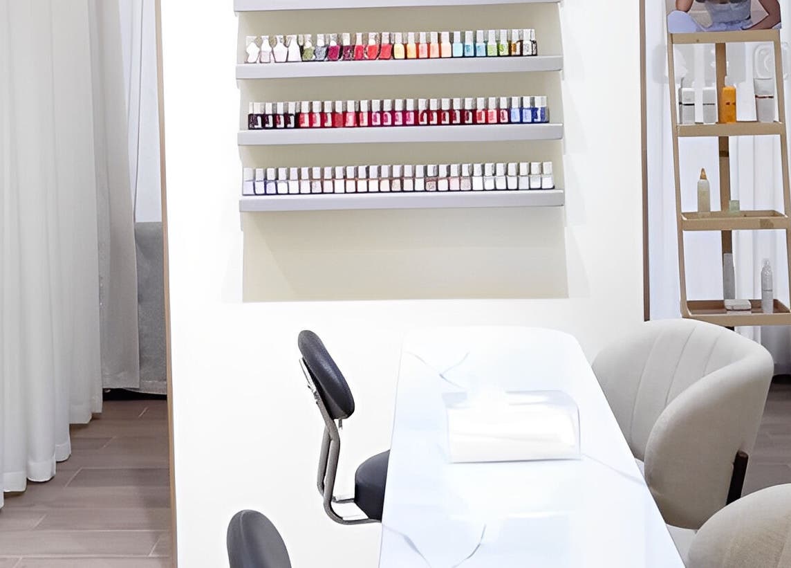 Nail bar at Maja Beauty Bar, Dubai. Elegant manicure station with chairs and nail polish display.
