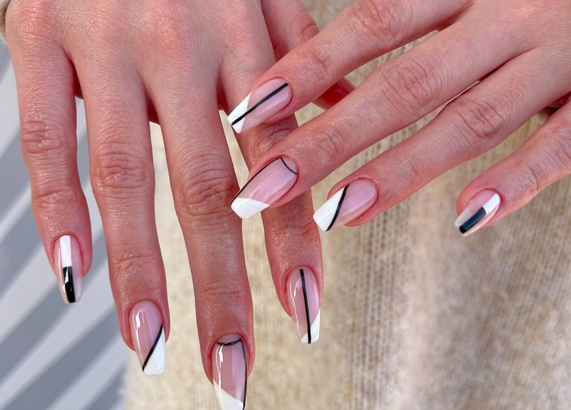 Modern manicure at Maja Beauty Bar, Dubai, Dubai, AE, showcasing elegant black and white nail art.