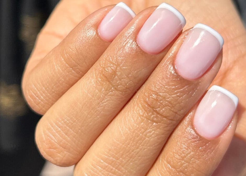 Elegant French manicure at Maja Beauty Bar, Dubai, Dubai, AE, showcasing glossy pink nails with white tips.