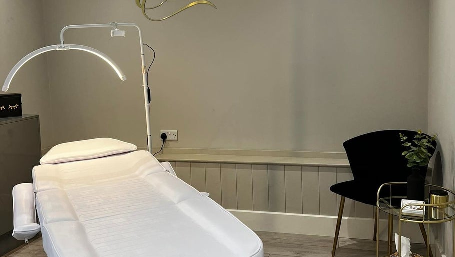 Tranquil treatment room at EK Beauty, Fareham, England, GB, featuring a plush bed and modern decor.