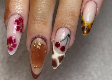 Stylish nail art designs at Nails by Katelyn in Ardfinnan, IE, featuring floral and cherry themes.