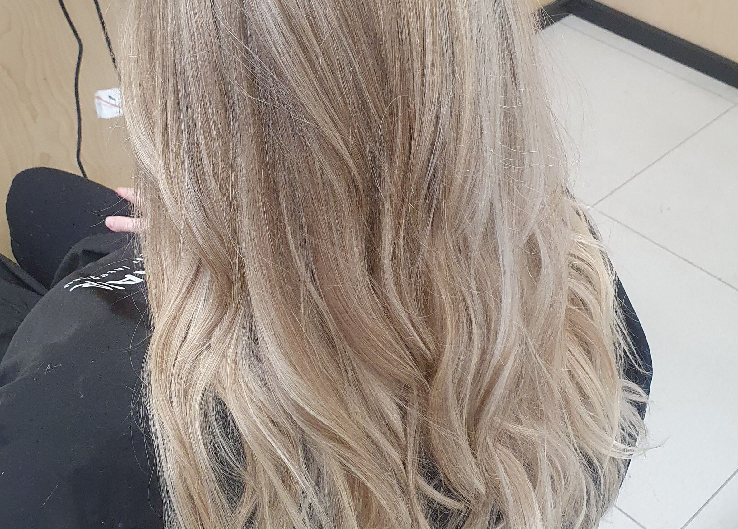 Elegant blonde hair styling at Colour By Case, Timaru, Canterbury, NZ. Perfect waves for a refined look.