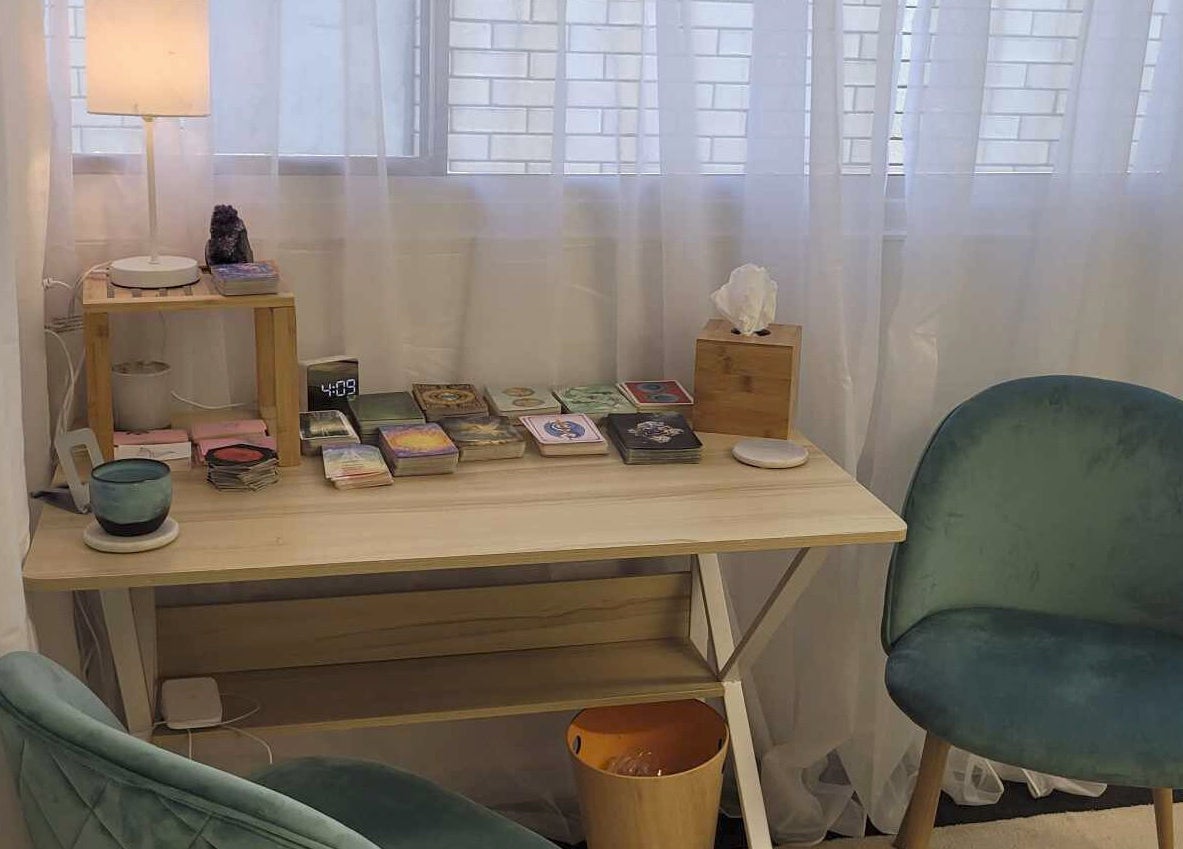 Calm therapy room at Metamorphosis Awakening, Tweed Heads, NSW, AU. Features chairs, table, and soft lighting.
