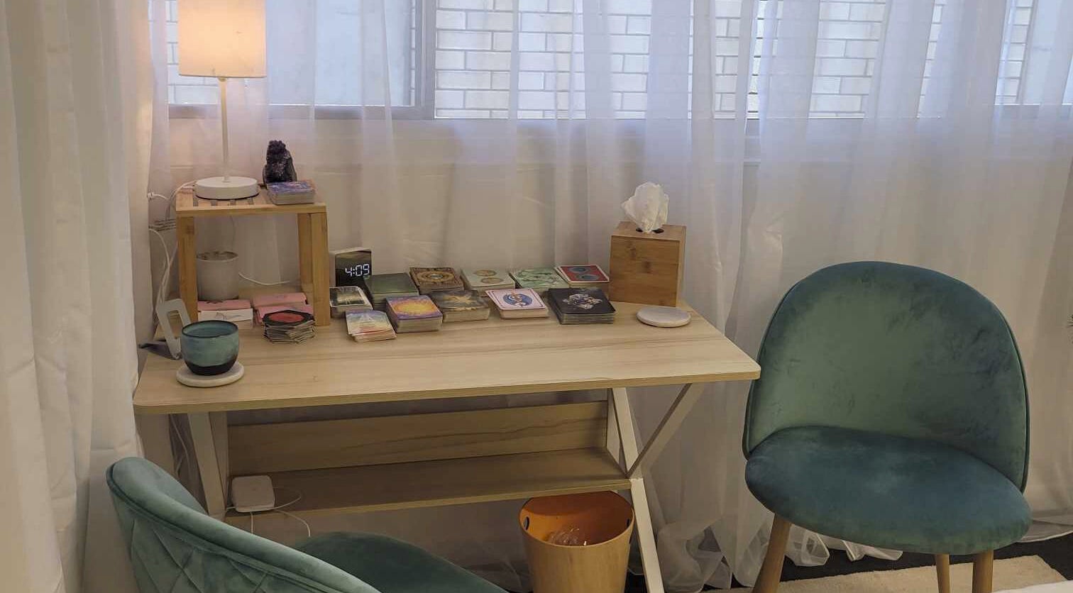 Calm therapy room at Metamorphosis Awakening, Tweed Heads, NSW, AU. Features chairs, table, and soft lighting.