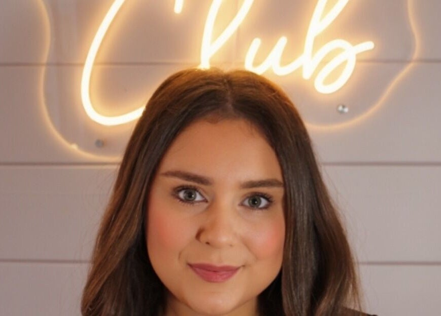 Profile in front of 'Club' neon sign at The Girls Club, Whittlesey, England, GB.