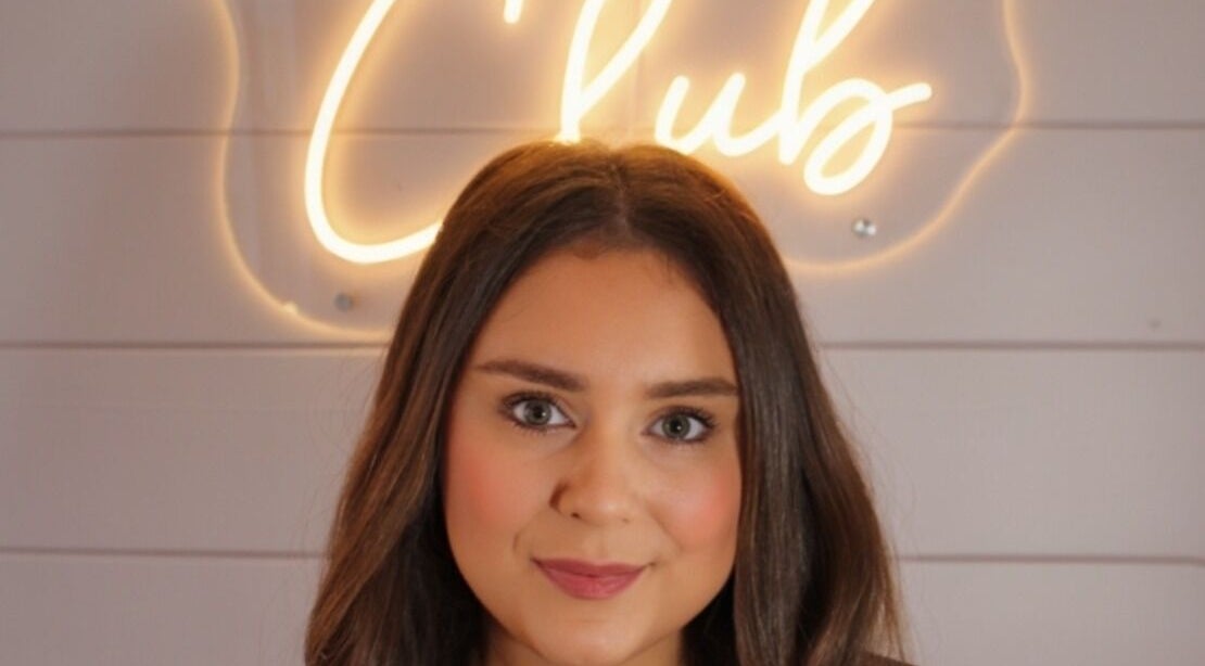 Profile in front of 'Club' neon sign at The Girls Club, Whittlesey, England, GB.