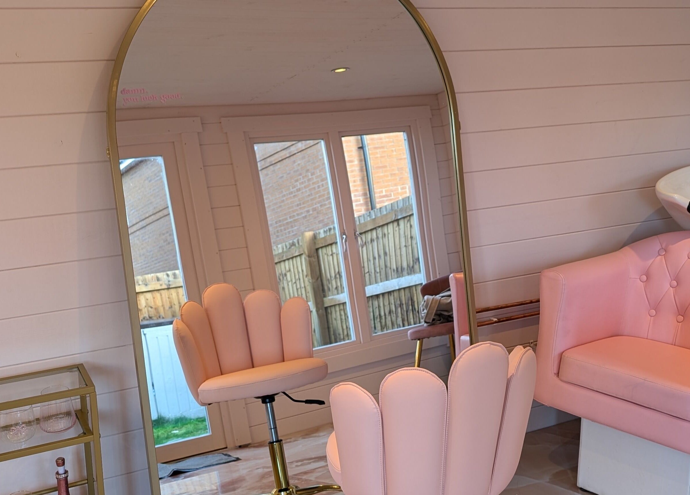 Stylish salon setup at The Girls Club in Whittlesey, England, GB, featuring pink chairs and a washing station.