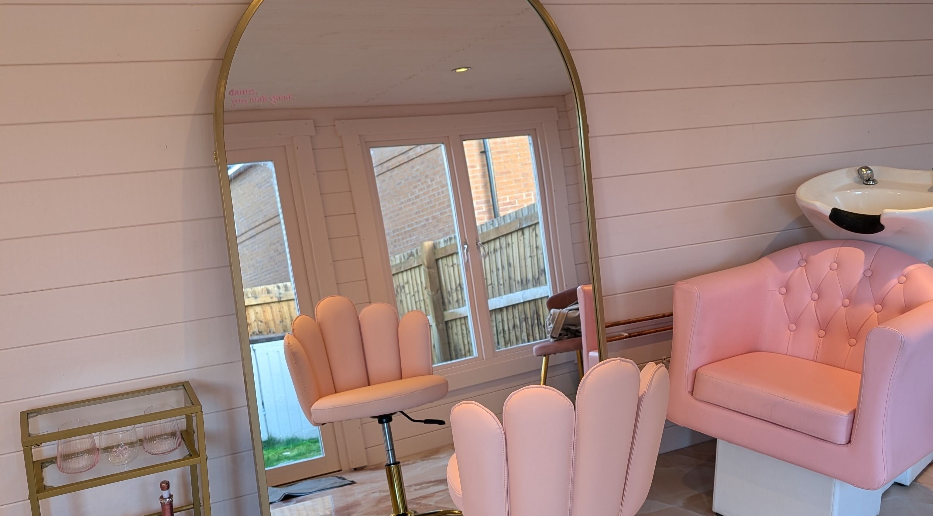 Elegant pink salon chairs and mirror at The Girls Club, Whittlesey, England, GB.
