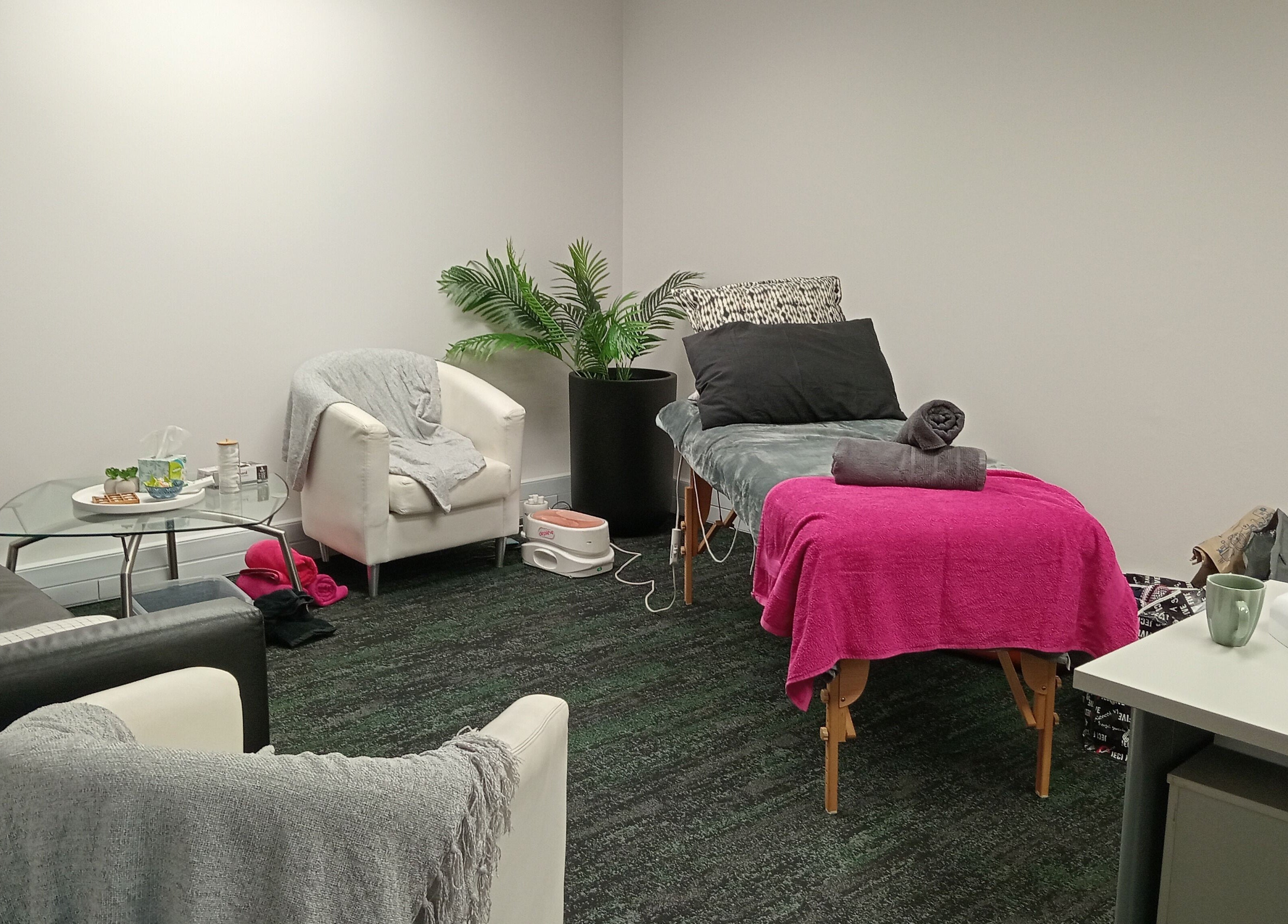 Relaxation room at ADG at Hensoldt Office in Irene, Centurion, Gauteng, ZA with cozy seating and a massage table.