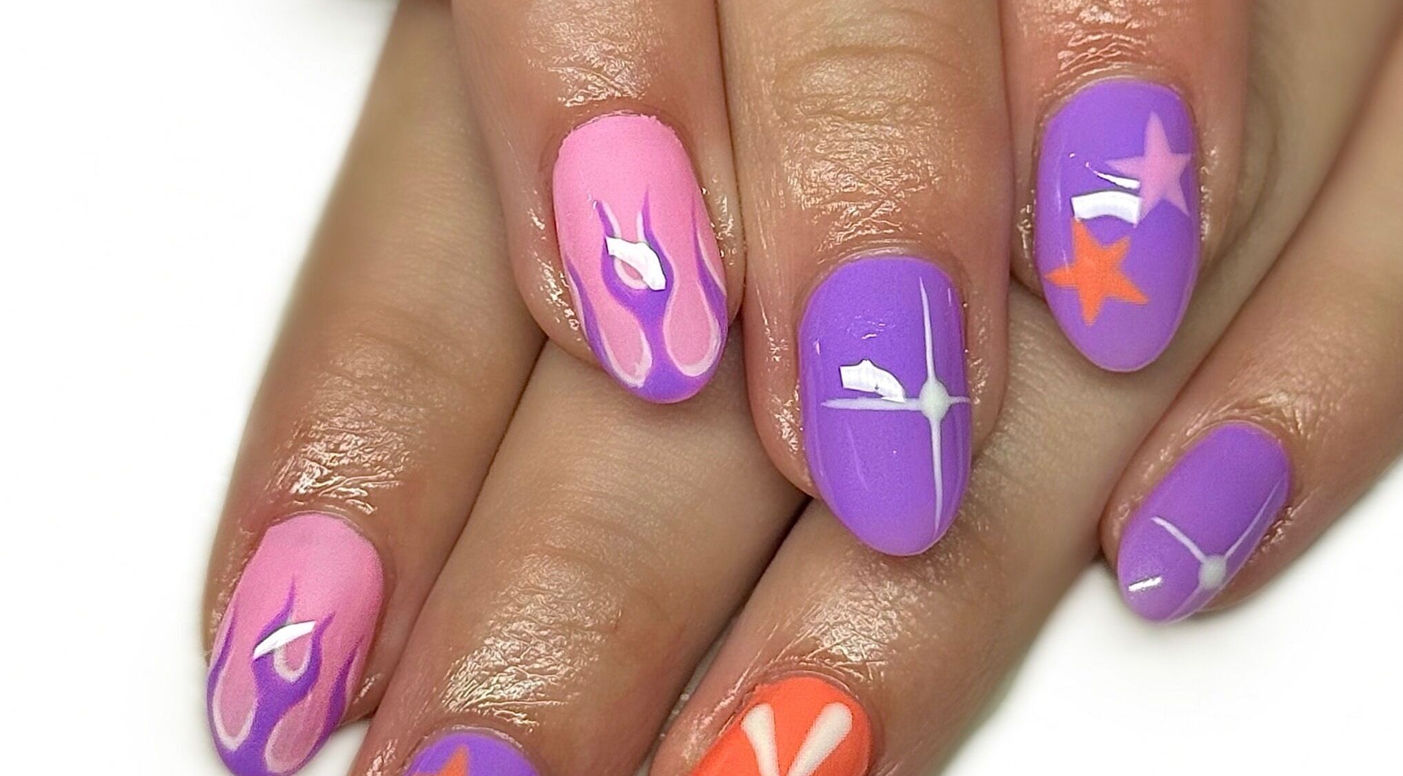 Colorful nail design at Nailed It With Jess in Ledbury, England, GB showcasing vibrant purple and pink patterns.