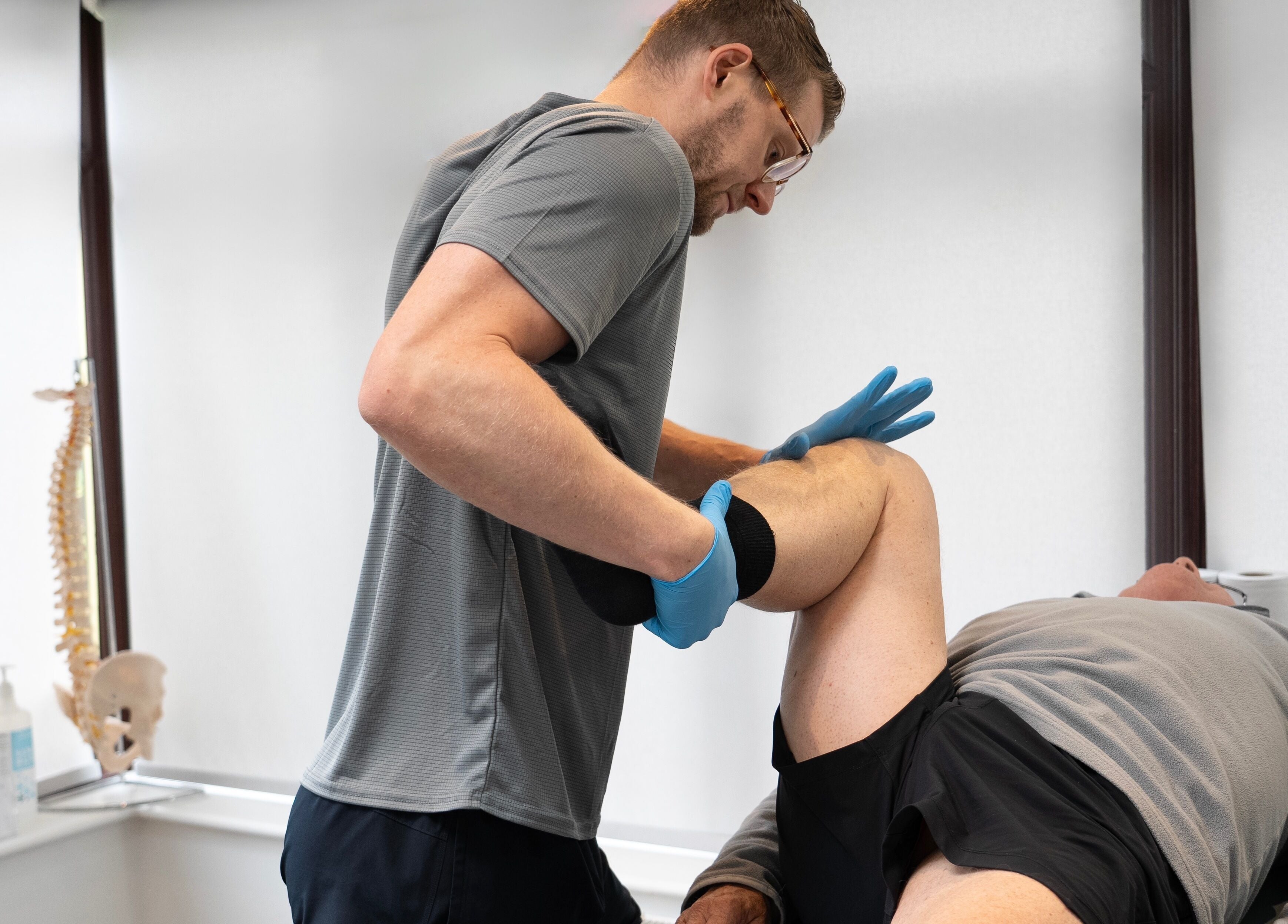 Therapist provides knee treatment at Energize Therapy, Droitwich Spa, England, GB.