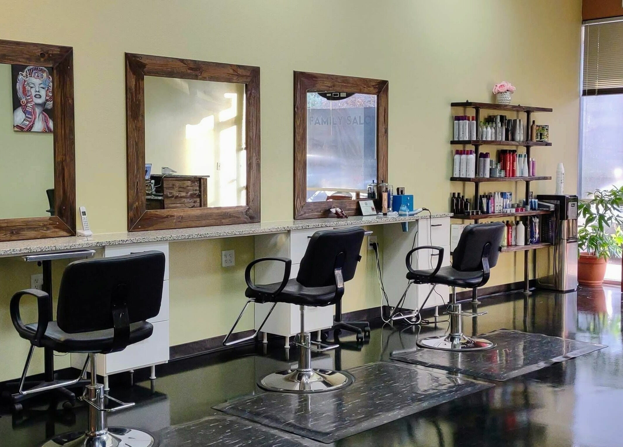 Modern salon chairs and mirrors at Creative Cuts, Austin, Texas, US. Bright, well-equipped interior space.