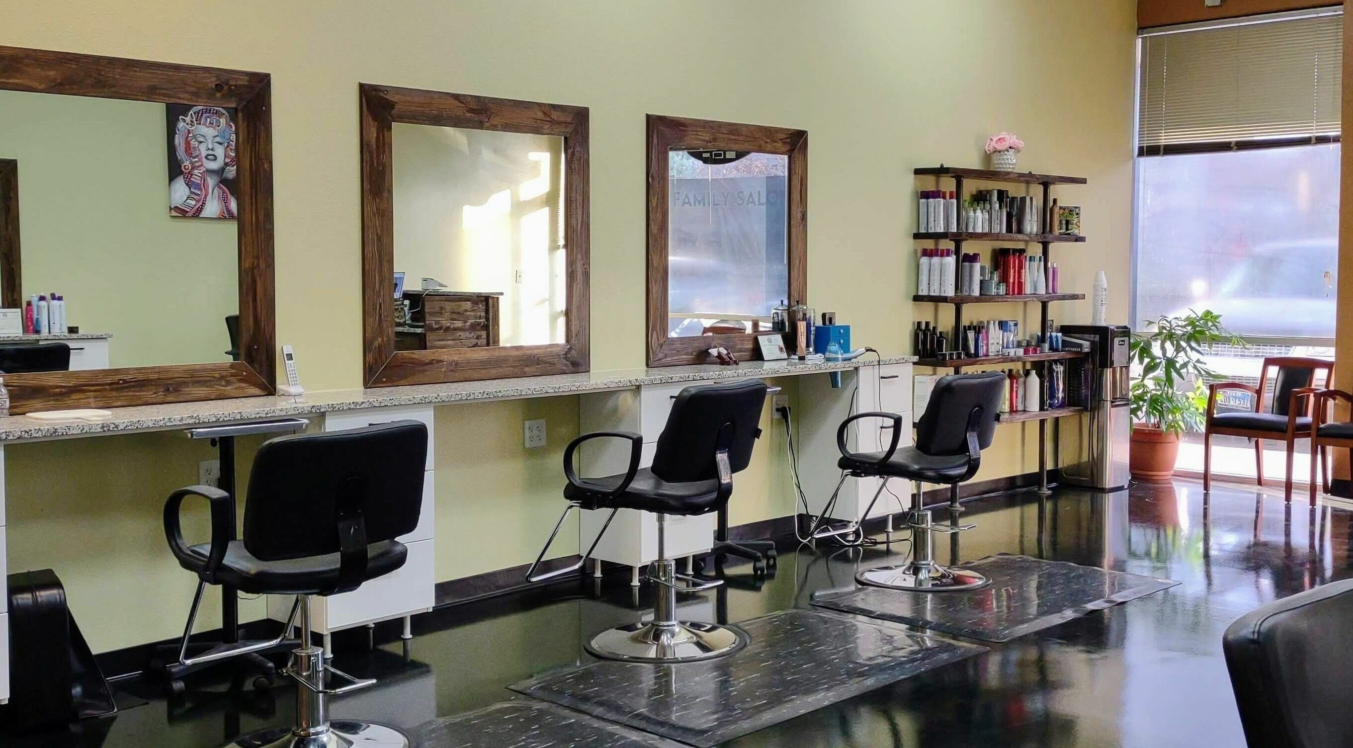 Modern salon chairs and mirrors at Creative Cuts, Austin, Texas, US. Bright, well-equipped interior space.