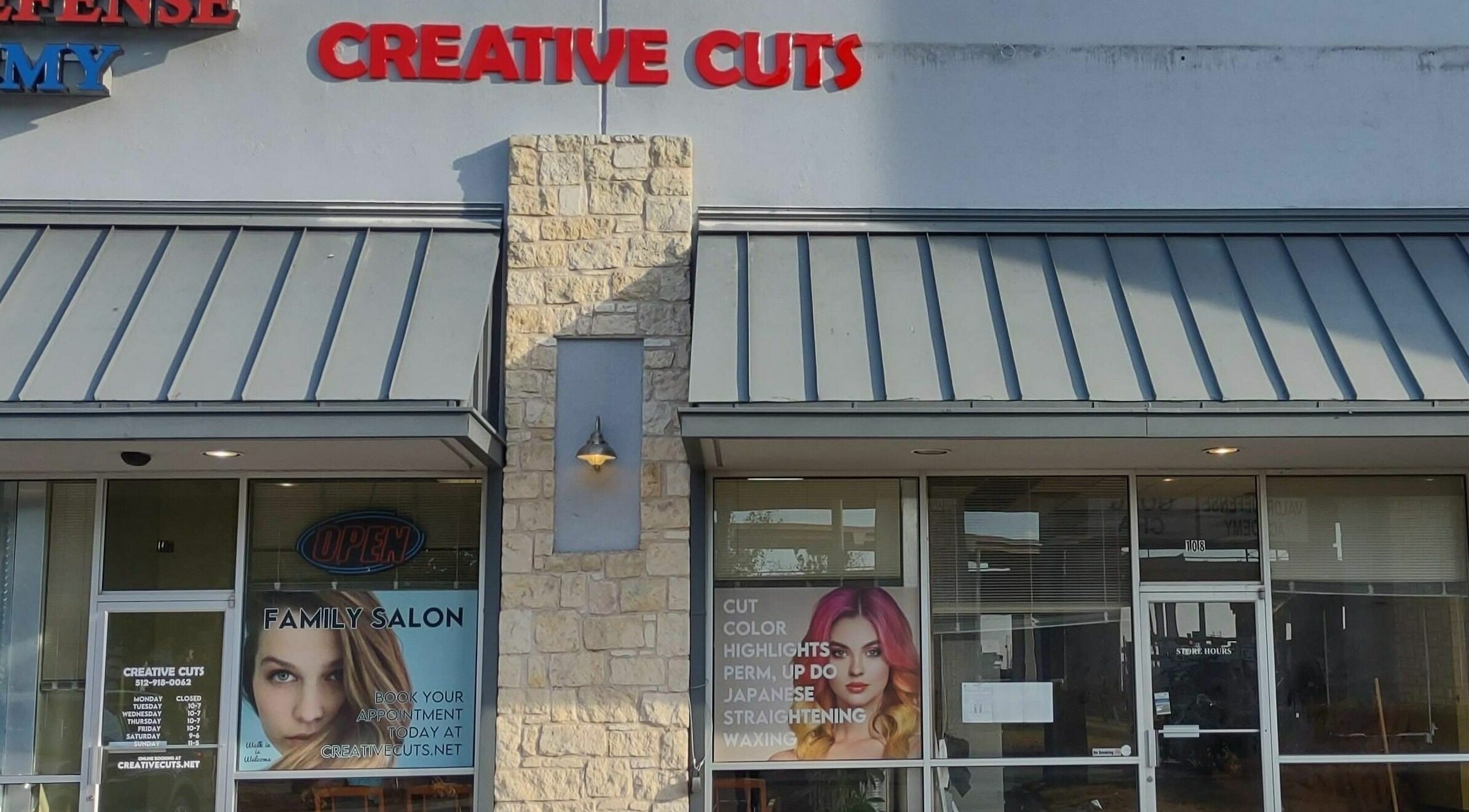Exterior view of Creative Cuts salon in Austin, Texas, US with bold signage.