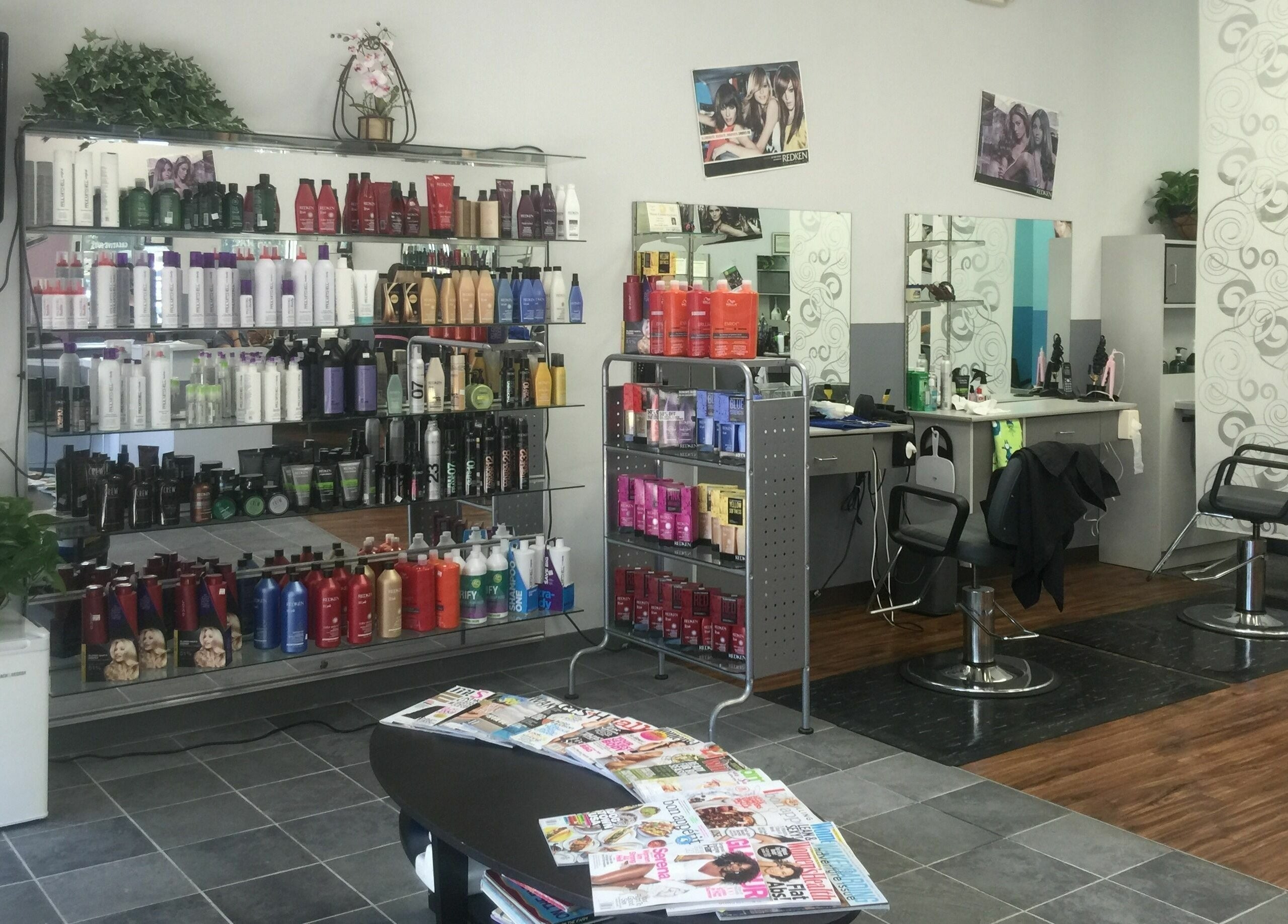 Creative Cuts salon interior in Austin, Texas, US, showcasing product shelves and styling stations.