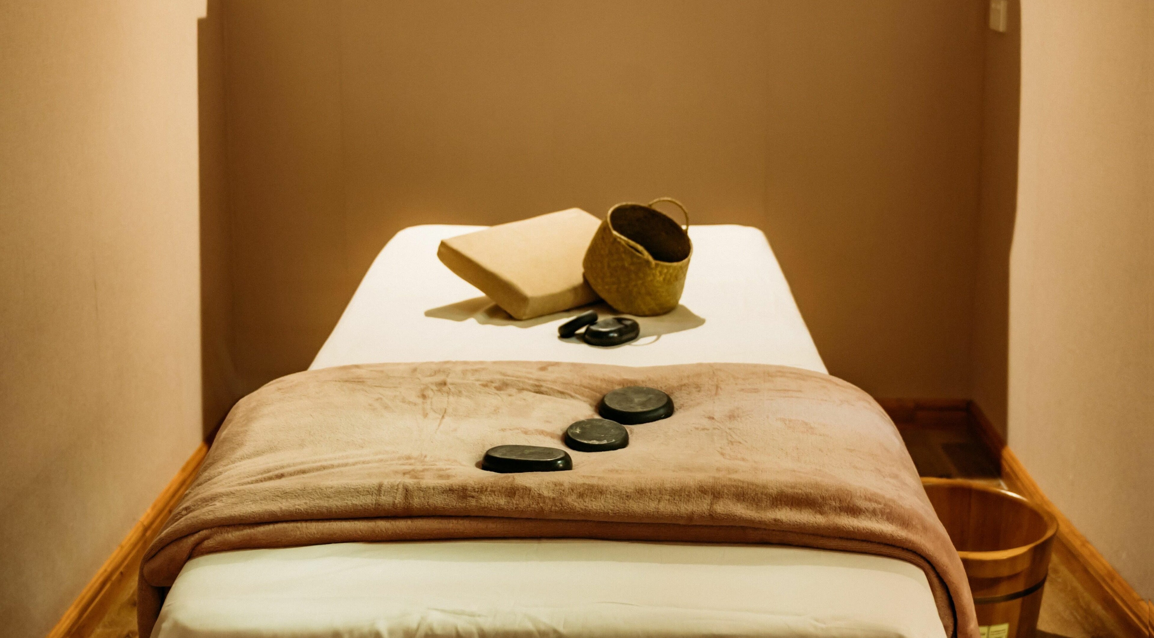 Cozy massage room at Lu’s Massage, Joondalup, Western Australia, AU, with hot stones on a plush towel.
