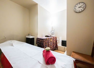 Relaxing massage room at Vavi Thai Massage Soho, London, England, GB with a neatly made bed and calming decor.