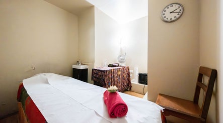 Relaxing massage room at Vavi Thai Massage Soho, London, England, GB with a neatly made bed and calming decor.