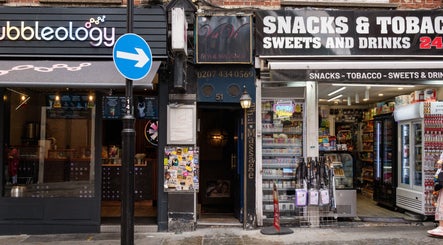 Entrance to Vavi Thai Massage Soho located in London, England, GB, nestled between shops.