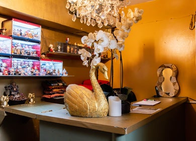 Golden swan decor and orchids at Vavi Thai Massage Soho reception, London, England, GB.