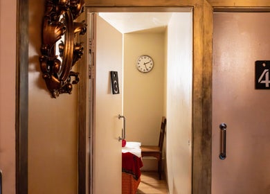 Cozy massage room at Vavi Thai Massage Soho, London, England, GB with warm decor and calming ambiance.