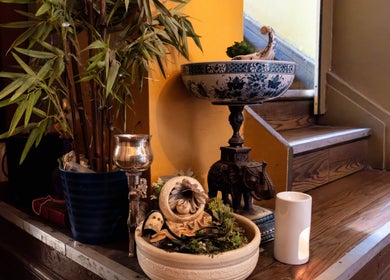 Elegant decor at Vavi Thai Massage Soho, London, England GB, featuring plants and ornaments on wooden stairs.