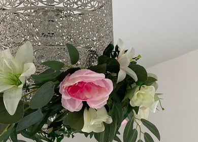 Ornate floral arrangement at Kami’s Brows, Lincoln, England, GB, featuring pink roses and delicate white lilies.