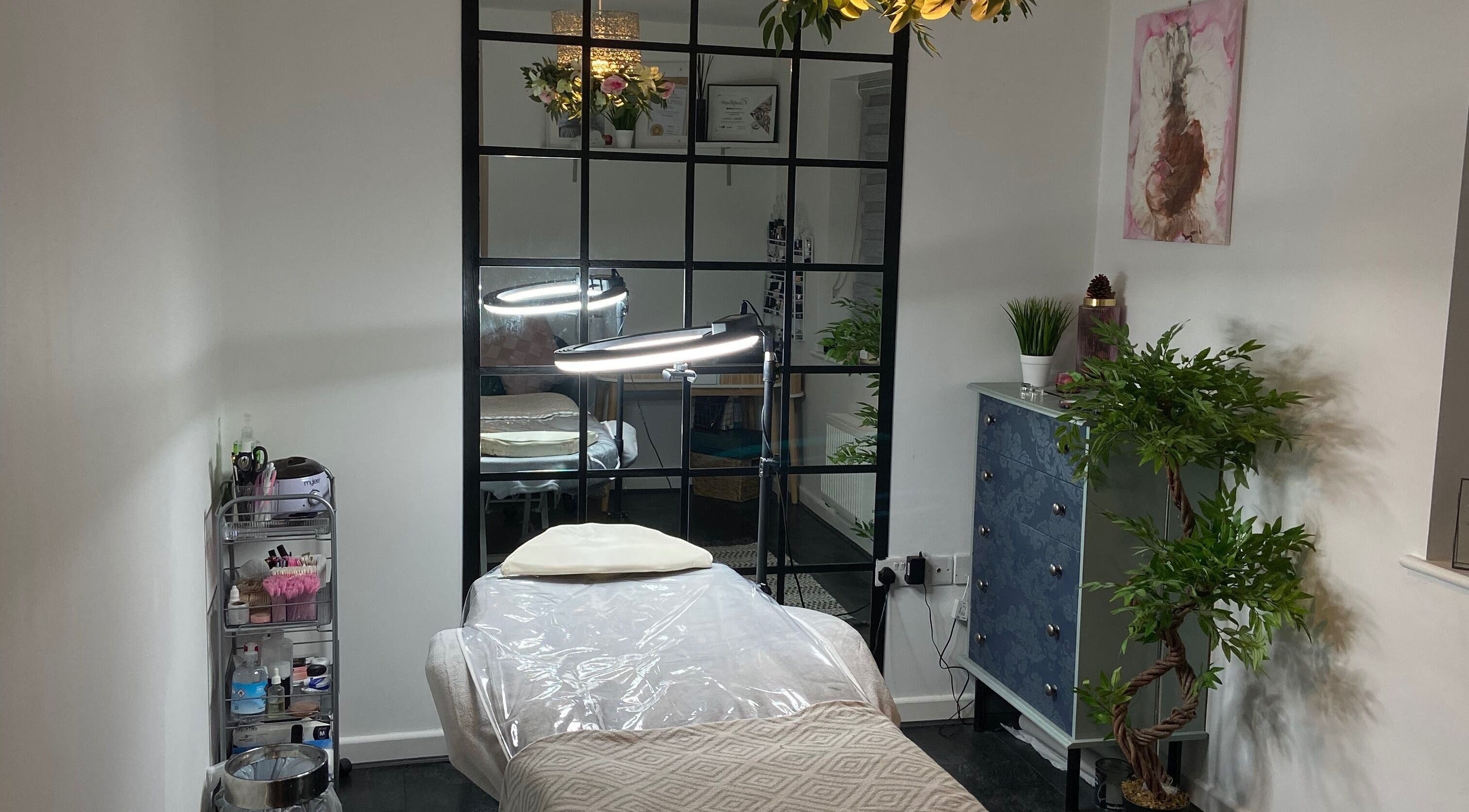 Serene treatment room at Kami’s Brows, Lincoln, England, GB, featuring a cozy bed and lush decor.