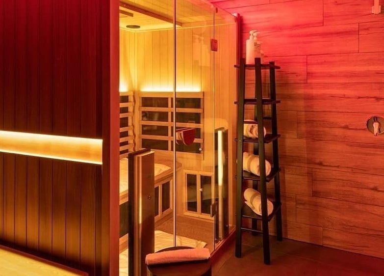 Relaxing sauna at Feel Good Nation, Leichhardt, New South Wales, AU with soft warm lighting and plush towels.