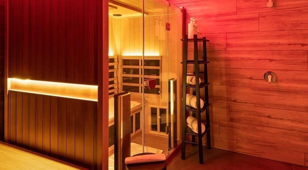 Relaxing sauna at Feel Good Nation, Leichhardt, New South Wales, AU with soft warm lighting and plush towels.