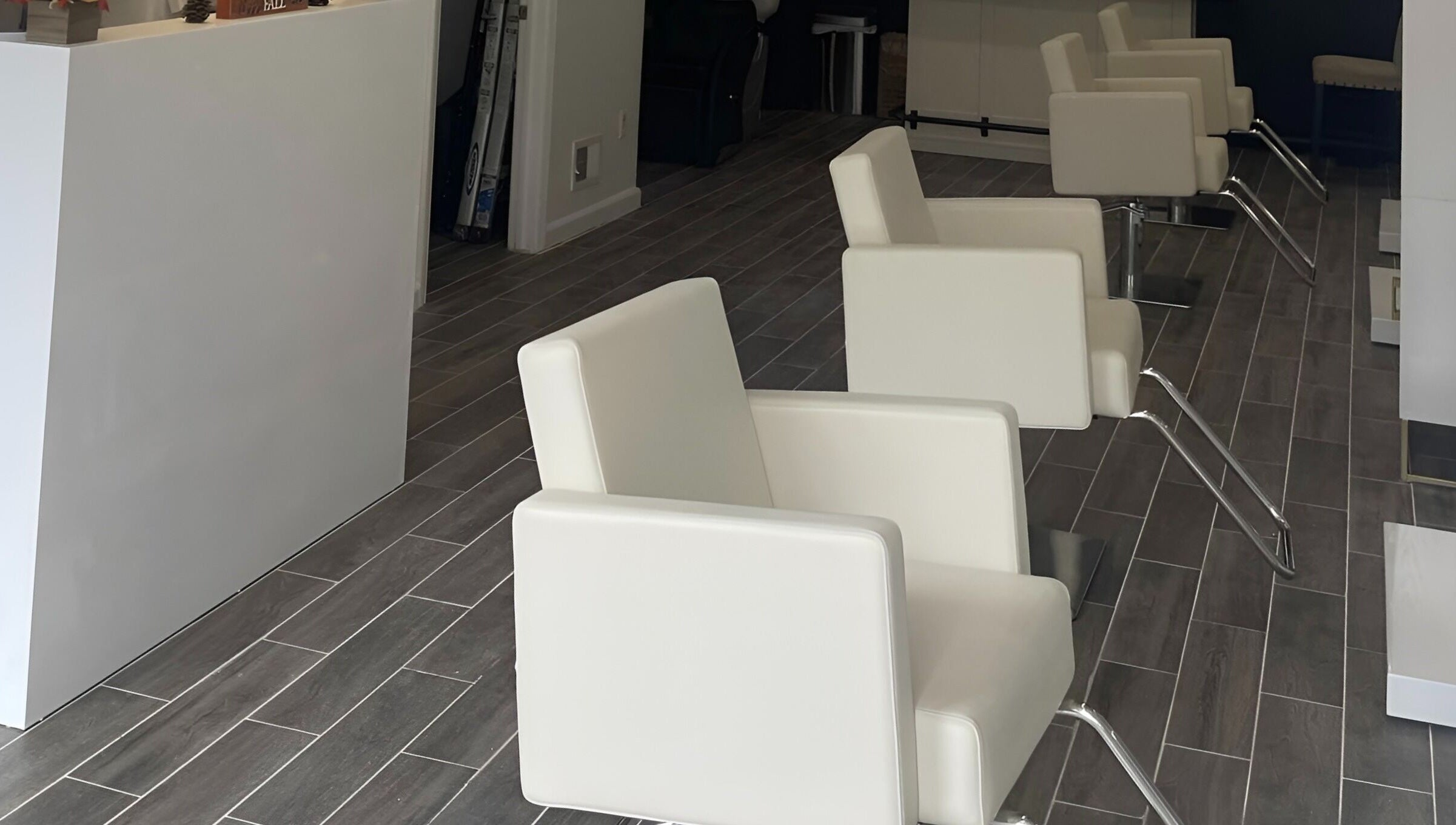 Sleek white salon chairs at Salon Lounge, New York, New York, US, showcasing modern elegance and comfort.