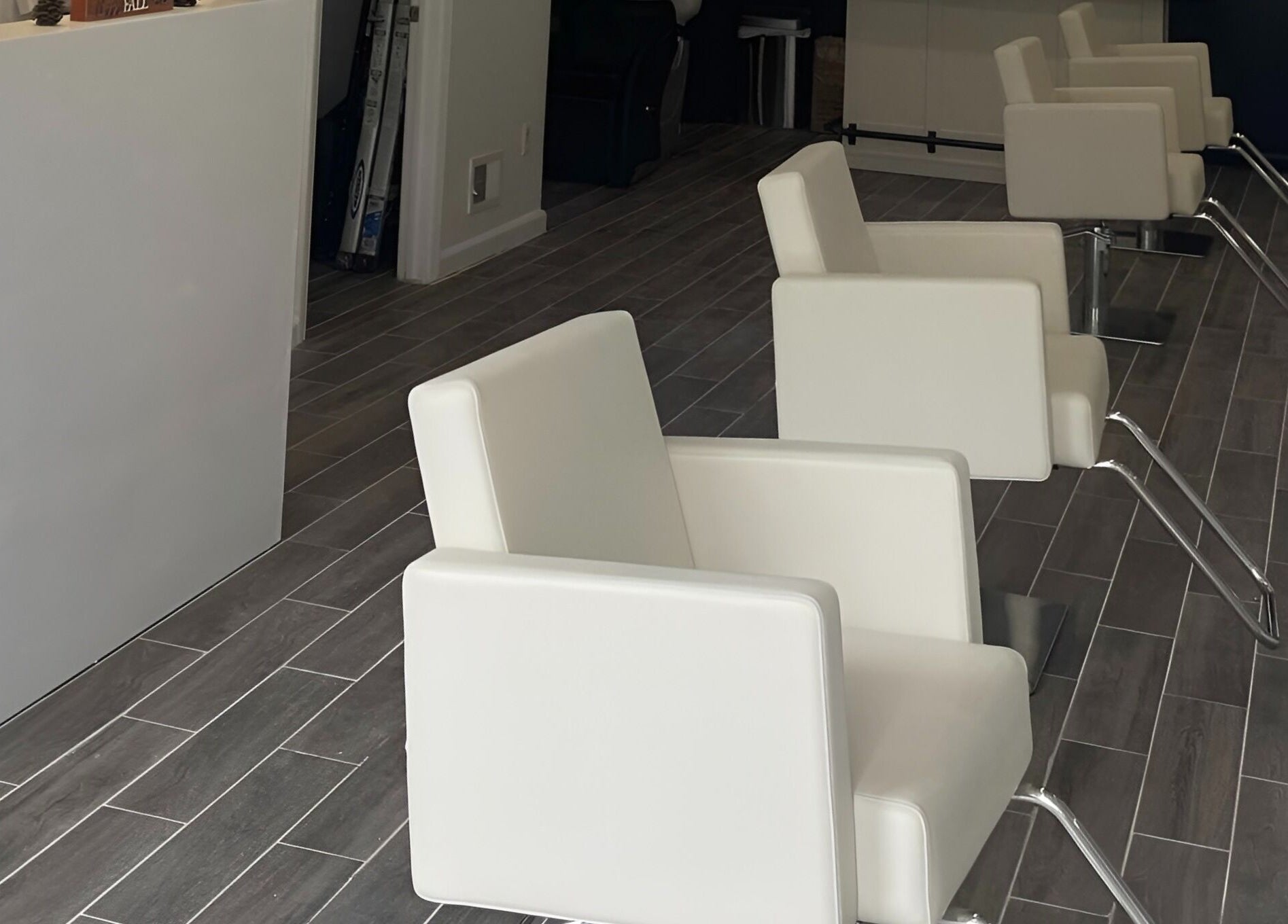 Sleek white salon chairs at Salon Lounge, New York, New York, US, showcasing modern elegance and comfort.