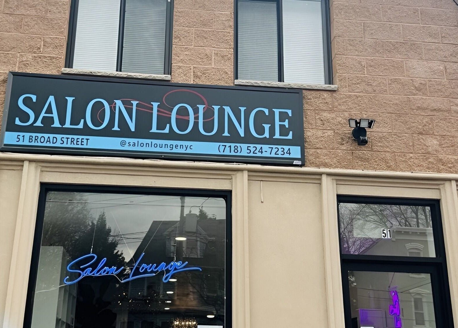 Exterior view of Salon Lounge at 51 Broad Street, New York, New York, US including signage.