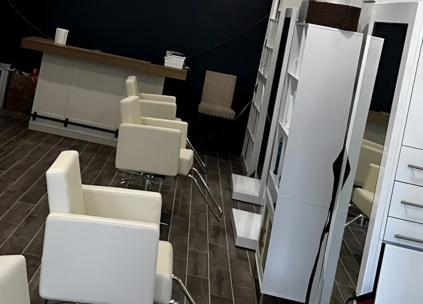 Modern Salon Lounge in New York, New York, US, featuring sleek white chairs and stylish decor.