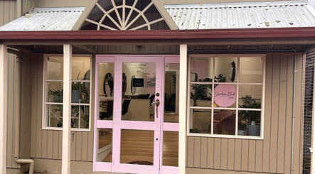 Exterior of Strawberri Blonde in Geeveston, Tasmania, AU, showcasing a welcoming entrance with pink accents.