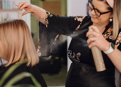 Stylist perfecting hairstyle at Strawberri Blonde, Geeveston, Tasmania, AU salon.