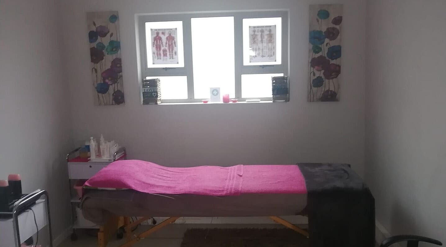 Massage room at Pink Me Up With Sue - EL, East London, Eastern Cape, ZA, featuring a cozy bed with pink accents.