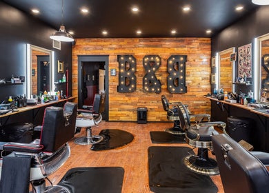 Modern barber chairs at Blades & Bourbon, Gatineau, Québec, CA showcasing sleek interior and vintage decor.