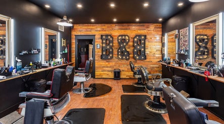 Modern barber chairs at Blades & Bourbon, Gatineau, Québec, CA showcasing sleek interior and vintage decor.