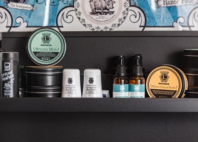 Grooming products at Blades & Bourbon, Gatineau, Québec, CA, featuring styling mud and beard oil.