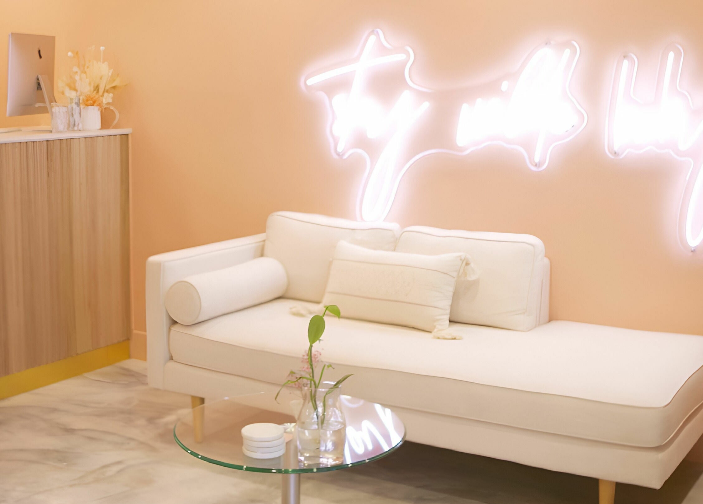 Elegant seating area with neon sign at Wilde Beauty Bar, Bundall, Queensland, AU.