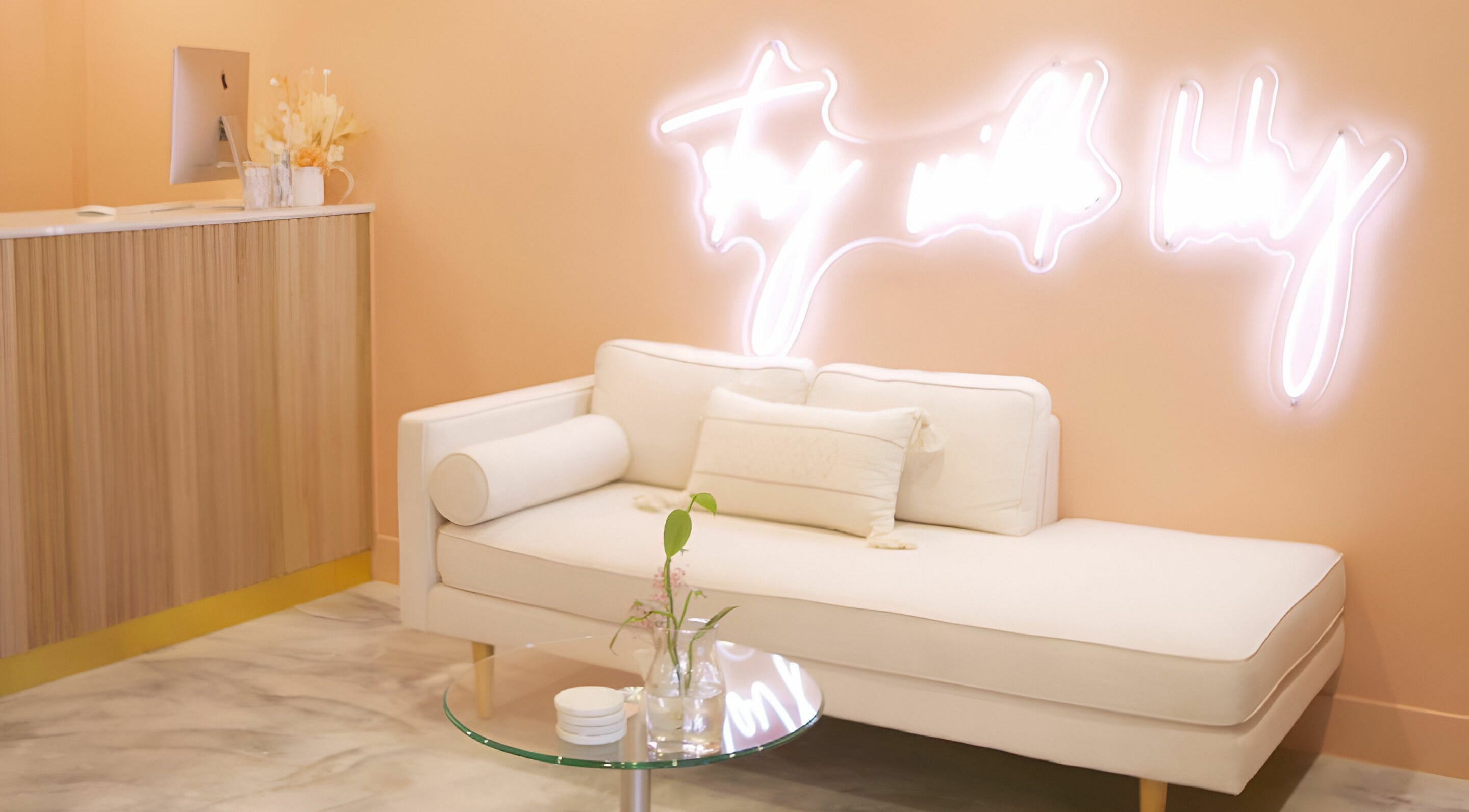 Elegant seating area with neon sign at Wilde Beauty Bar, Bundall, Queensland, AU.