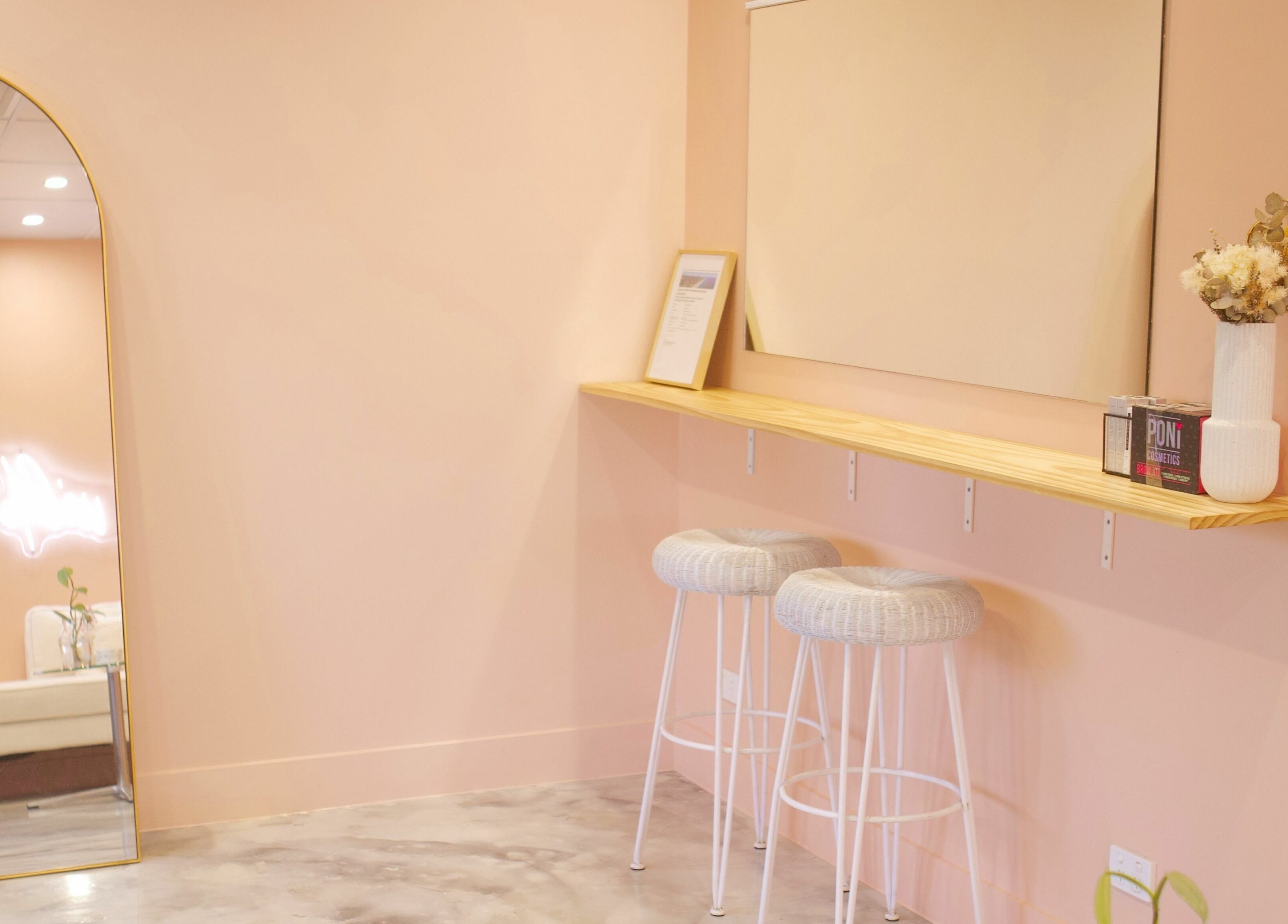 Chic interior of Wilde Beauty Bar, Bundall, Queensland with soft pink walls and stylish seating area.
