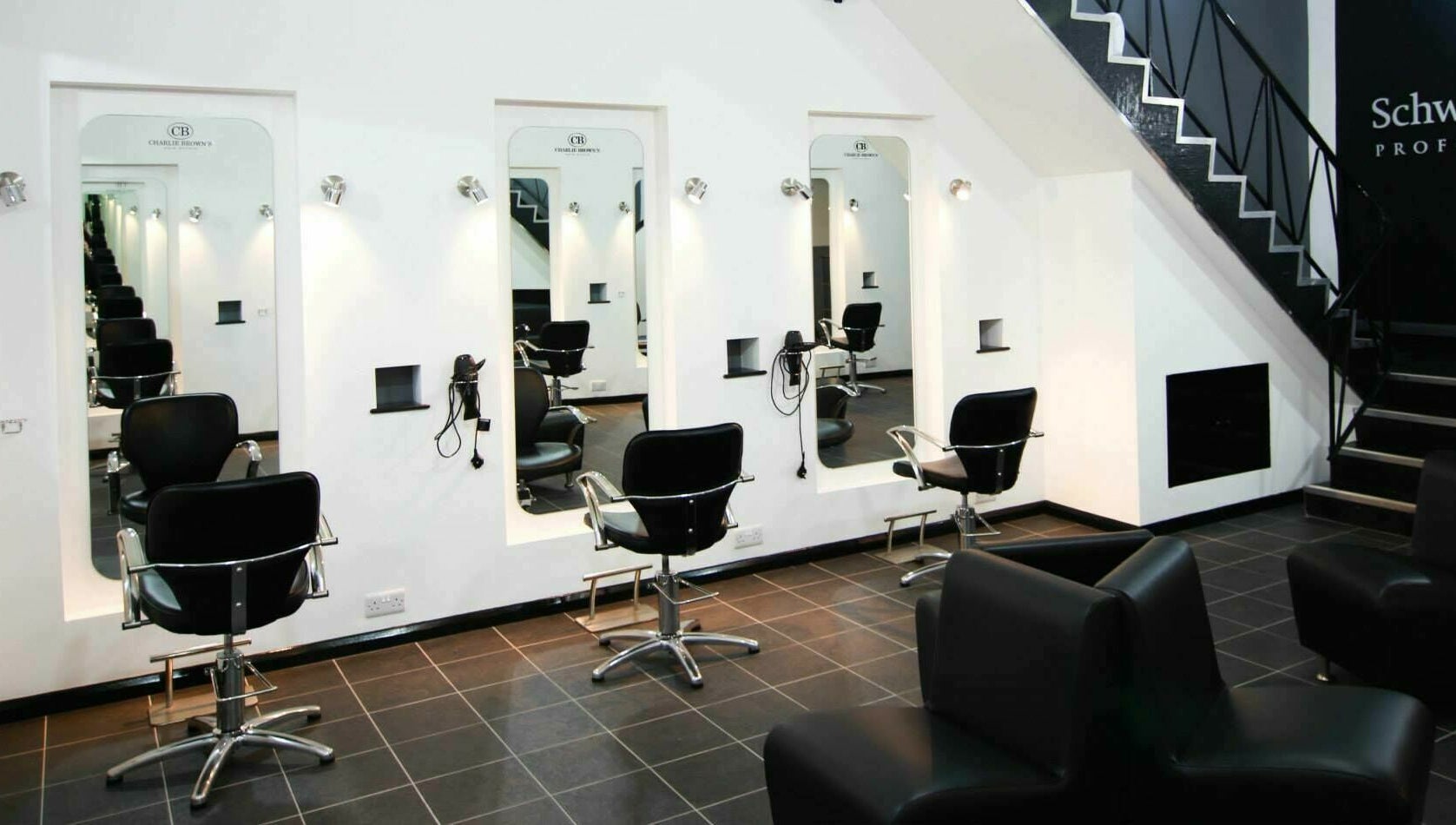 Modern salon chairs at Charlie Browns Hair Studio Ltd, Stoke-on-Trent, England, GB with sleek design.