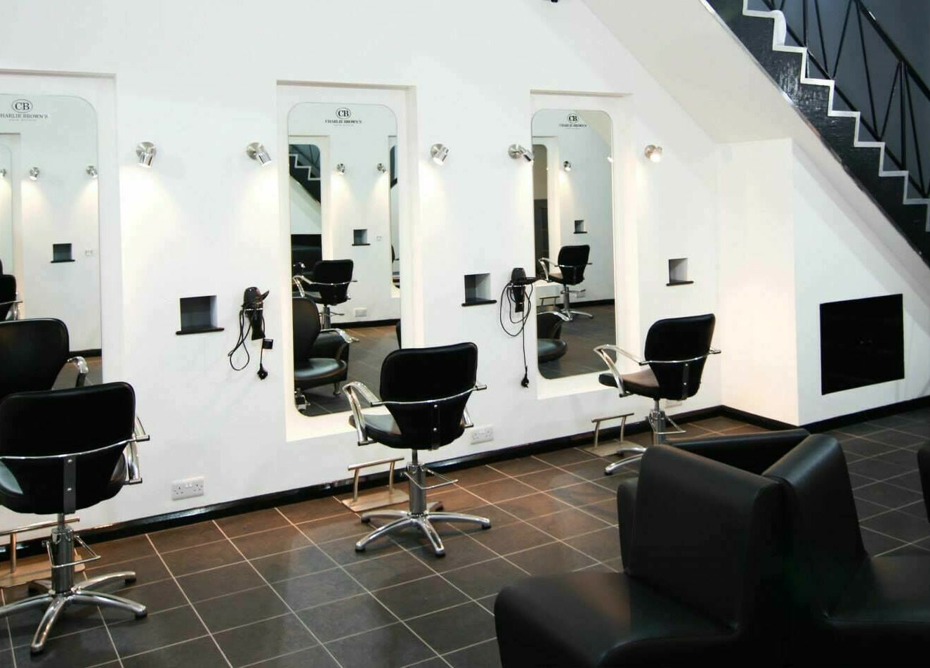 Modern salon chairs at Charlie Browns Hair Studio Ltd, Stoke-on-Trent, England, GB with sleek design.