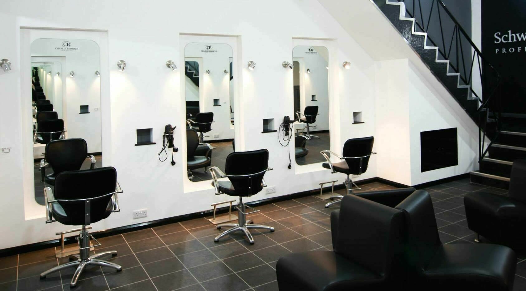 Modern salon chairs at Charlie Browns Hair Studio Ltd, Stoke-on-Trent, England, GB with sleek design.