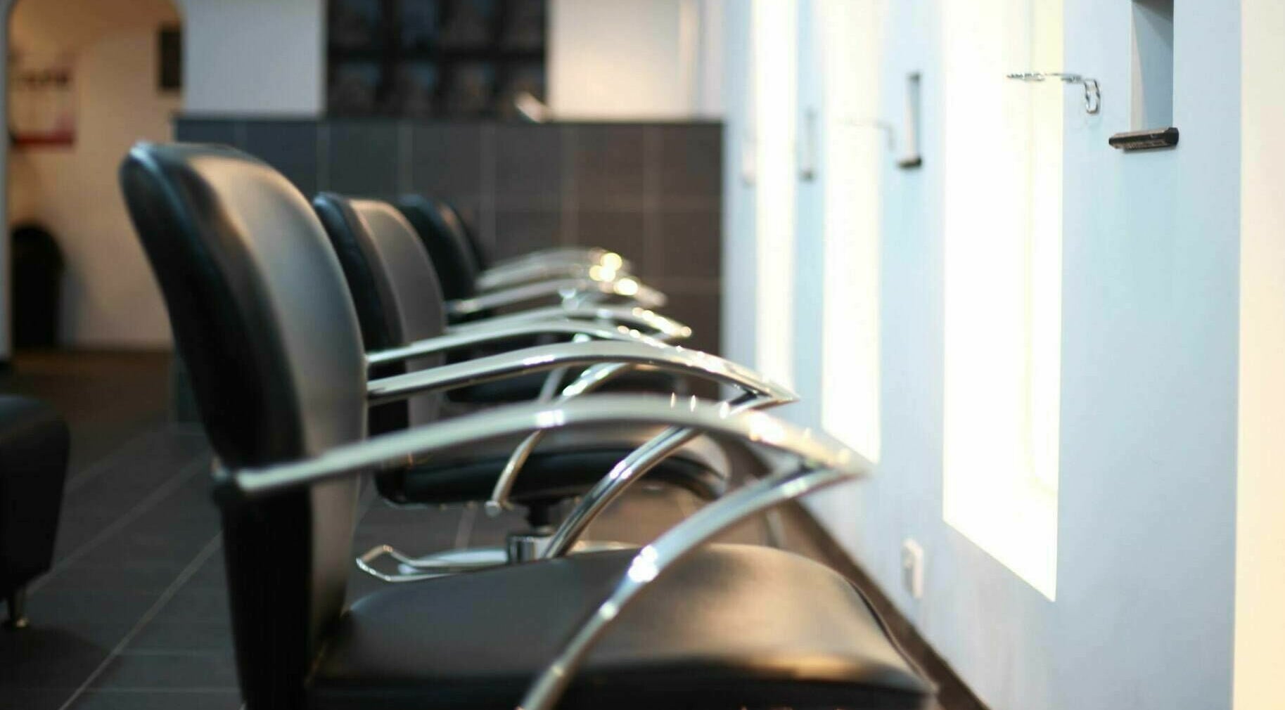 Modern salon chairs at Charlie Browns Hair Studio Ltd, Stoke-on-Trent, England, GB, showcasing sleek style.
