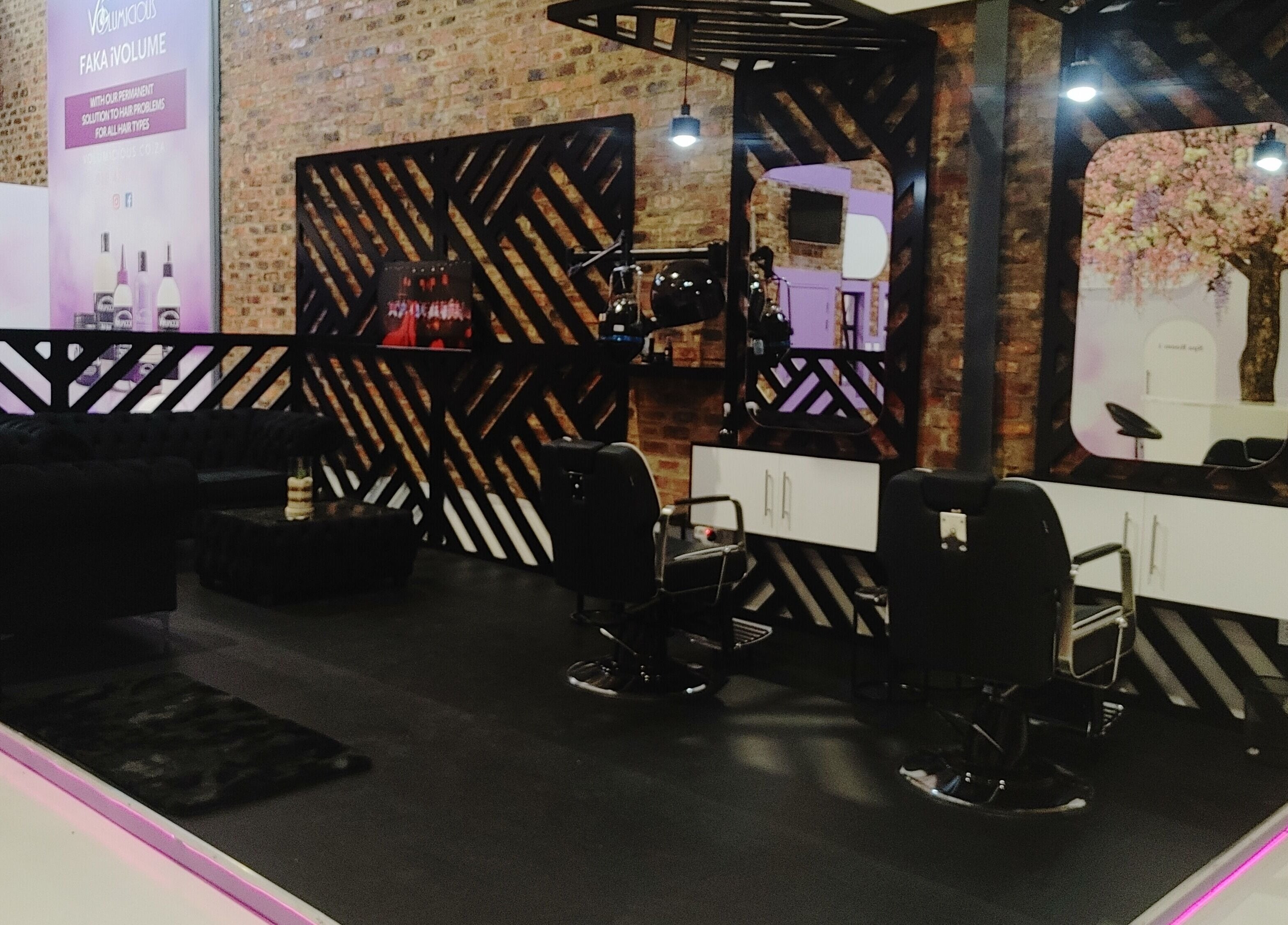 Sleek interior of Volumicious Riversands salon, Johannesburg, Gauteng, ZA, featuring stylish mirrors and chairs.