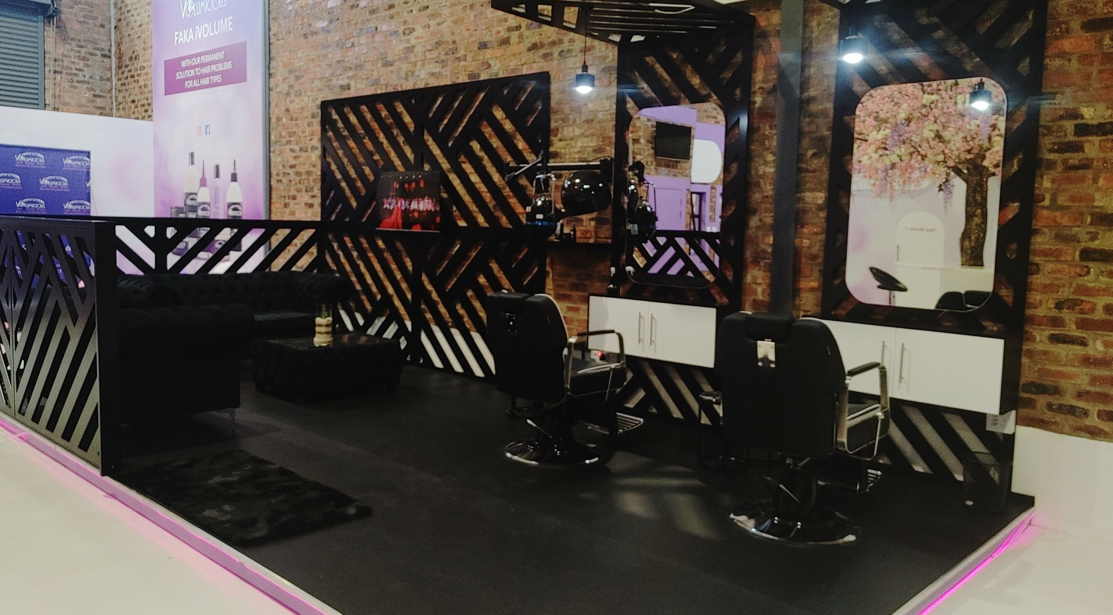 Sleek interior of Volumicious Riversands salon, Johannesburg, Gauteng, ZA, featuring stylish mirrors and chairs.